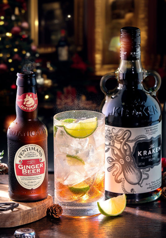 A bottle of Fentimans Ginger Beer with a bottle of Kraken rum and a highball serve garnished with limes