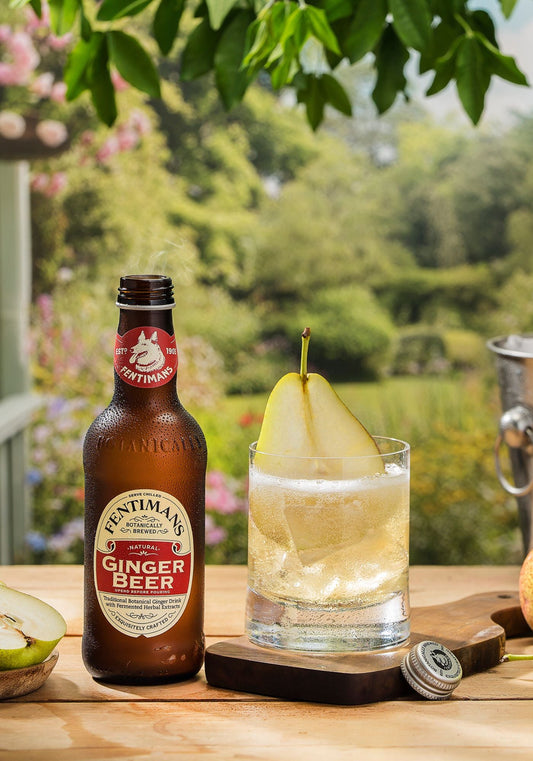 The 1905 cocktail made with Fentimans Ginger Beer in a short glass with a sliced pear in a garden setting